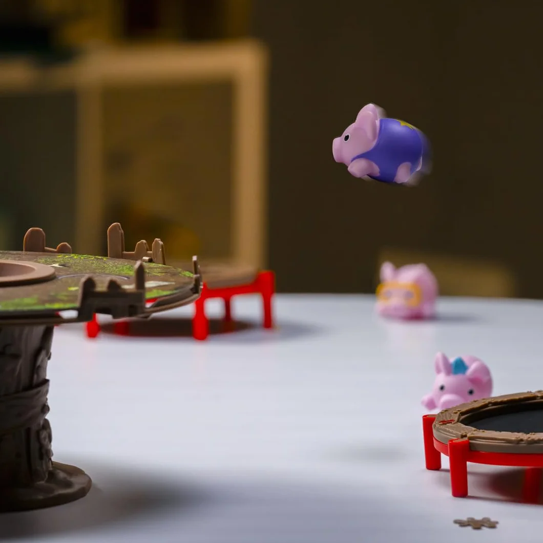 PlayMonster Świnie na trampolinach | Zabawna gra dla dzieci z odbijającymi się świniami | Szybka gra rodzinna | Dla dzieci w wieku od 6 lat