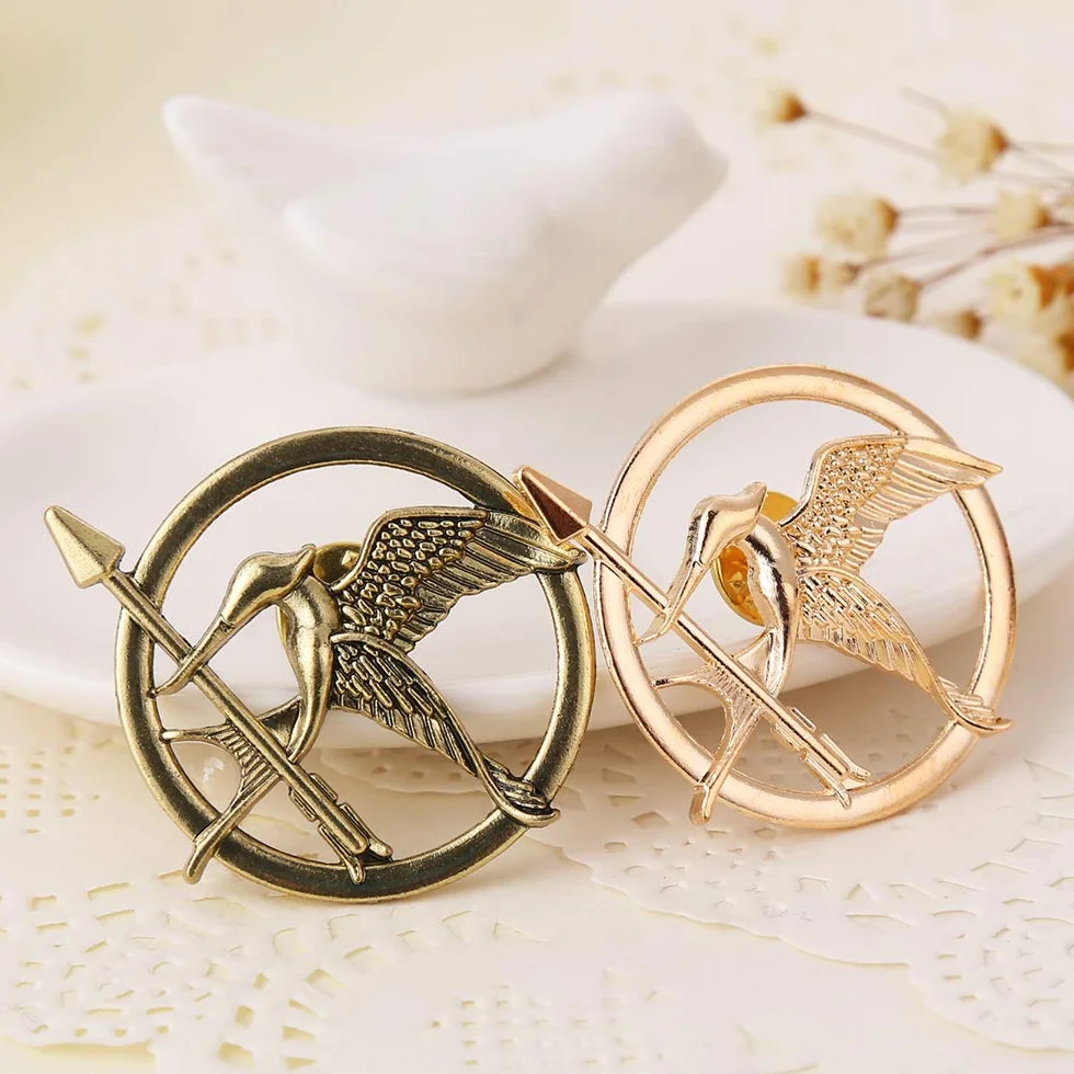 Igrzyska śmierci film kosogłos rekwizyty reprezentatywna przypinka szydzący ptak osobowość logo odznaka, złota